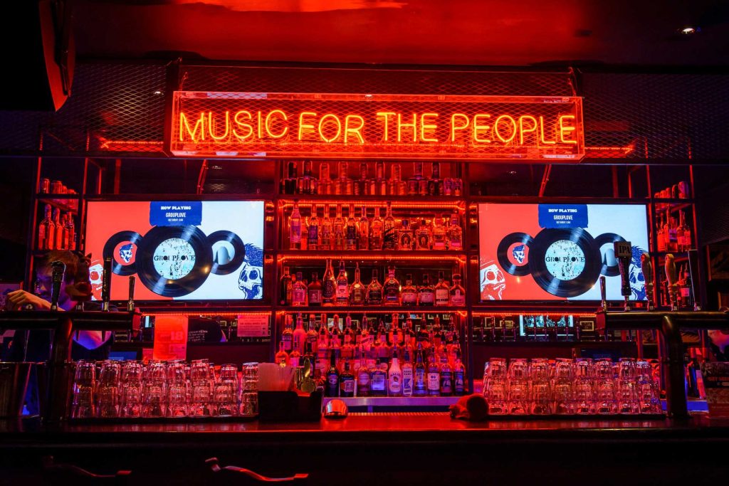 a bar with red neon signs